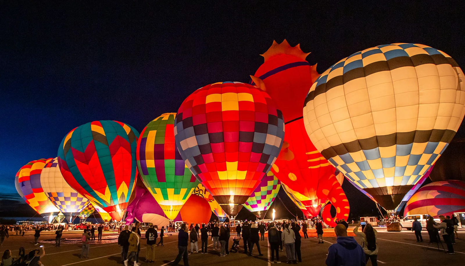 Colorful hot air balloons glowing at night during the Lake Havasu Balloon Festival