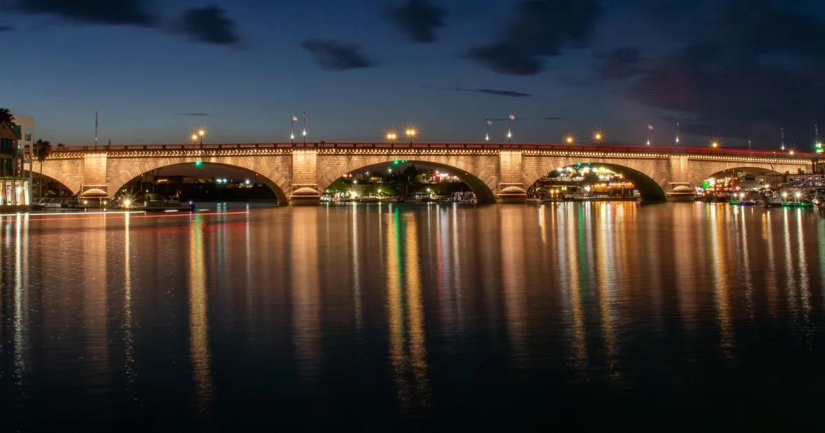 The historic London Bridge lit up at night over the Bridgewater Channel in Lake Havasu City